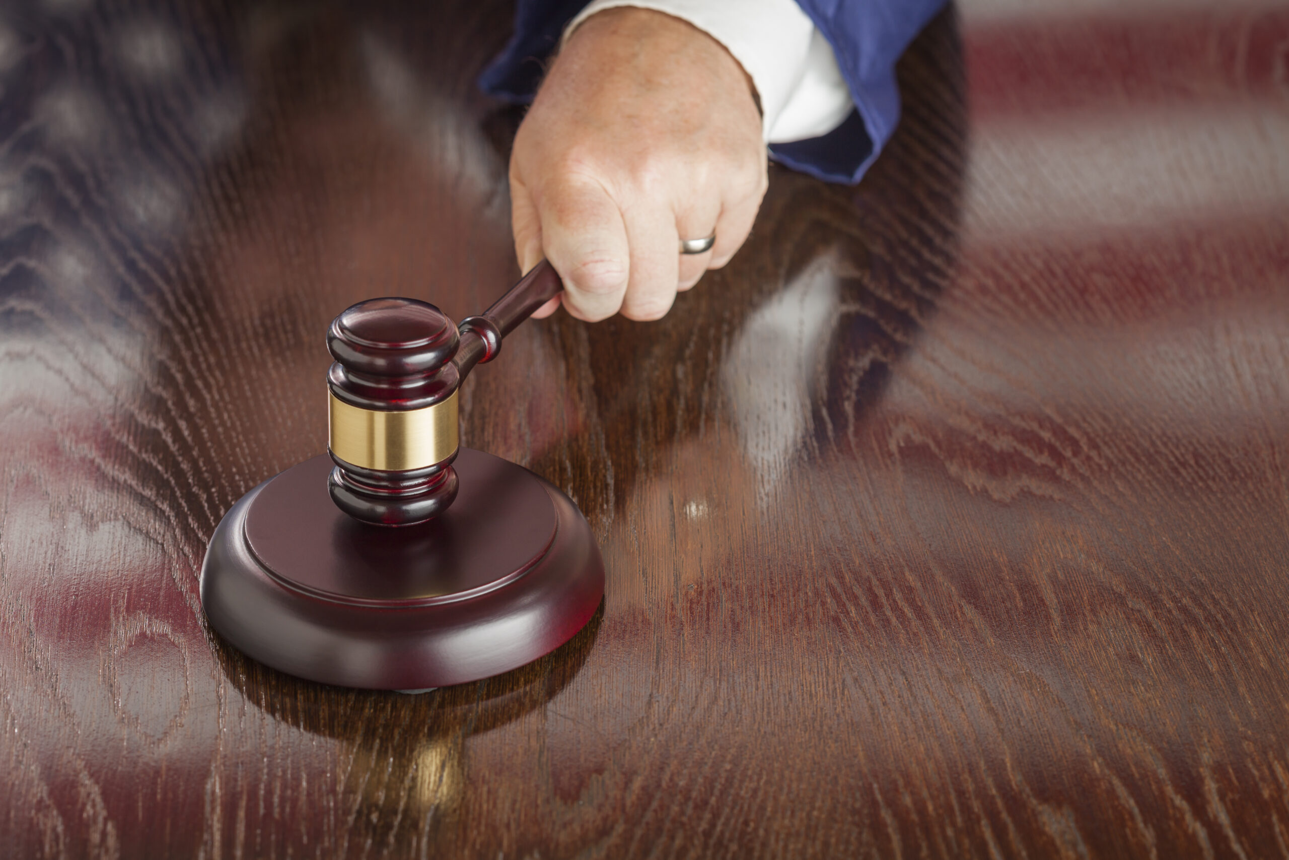 Judge Slams His Gavel and American Flag Table Reflection.